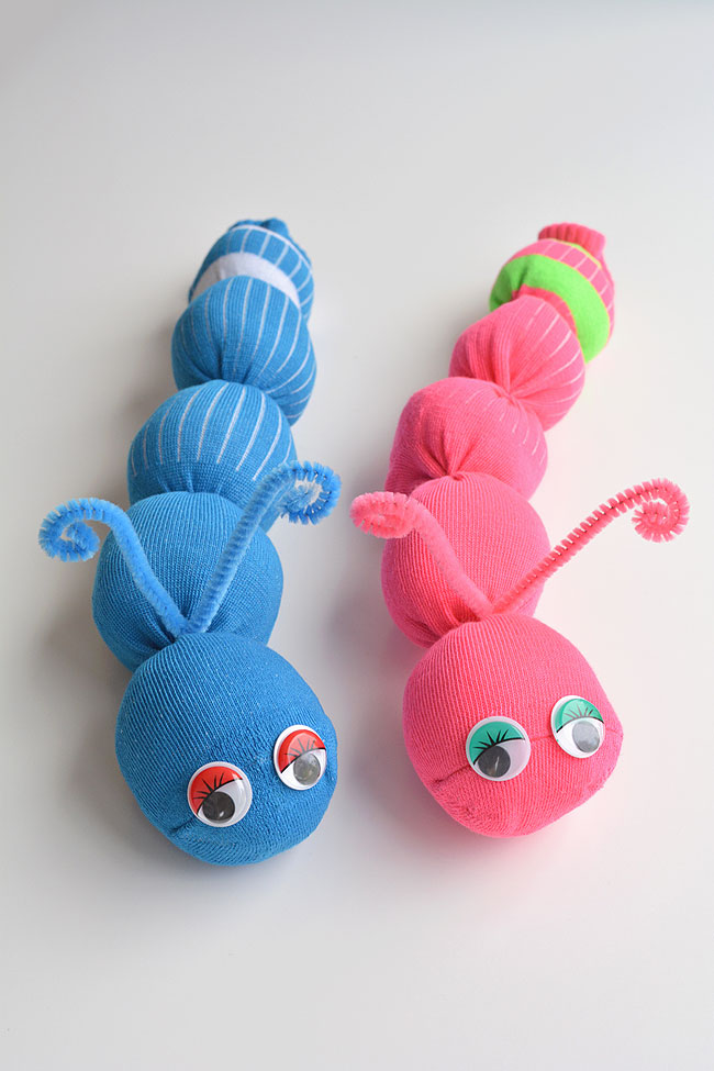 sock-worms Two stuffed worms- one pink and one blue- sit side by side