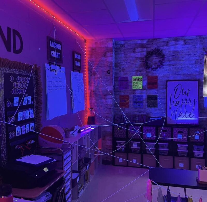 A classroom is setup with some spy themes including string setup like a trap.