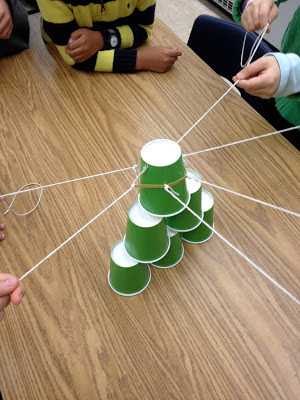 cup-stacking-2 Green paper cups with strings attached stacked on a table as example of job readiness skills