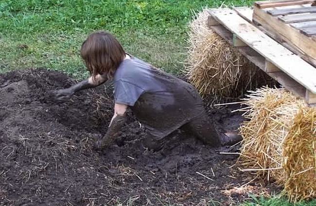 DIY Obstacle Courses for Kids: Mud Run Child crawling through the mud underneath planks laid across hay bales in this example of obstacle courses for kids