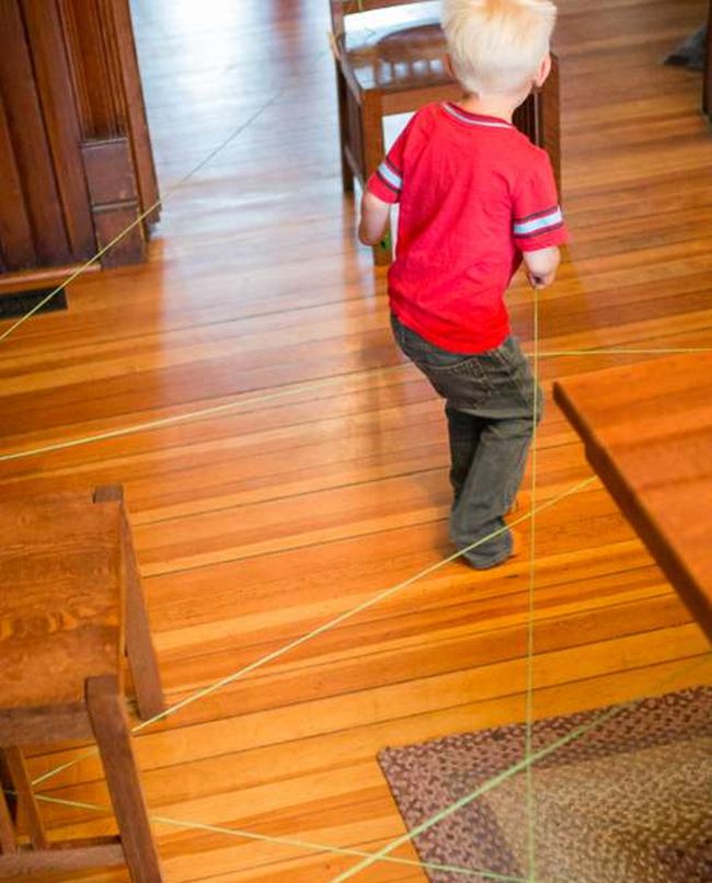 DIY Obstacle Courses for Kids: String Child following a string obstacle course maze