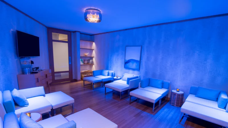 Hotel room with blue walls and blue lighting