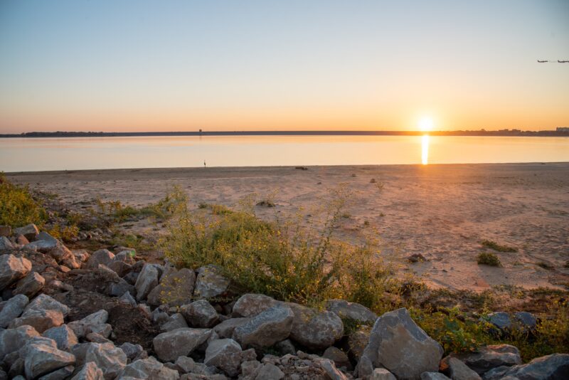 Beach at sunset with rocks and sand
