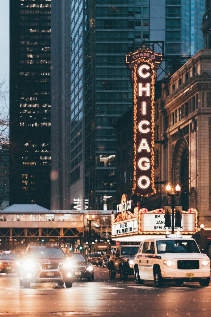Sign that says Chicago with skyscrapers in the background