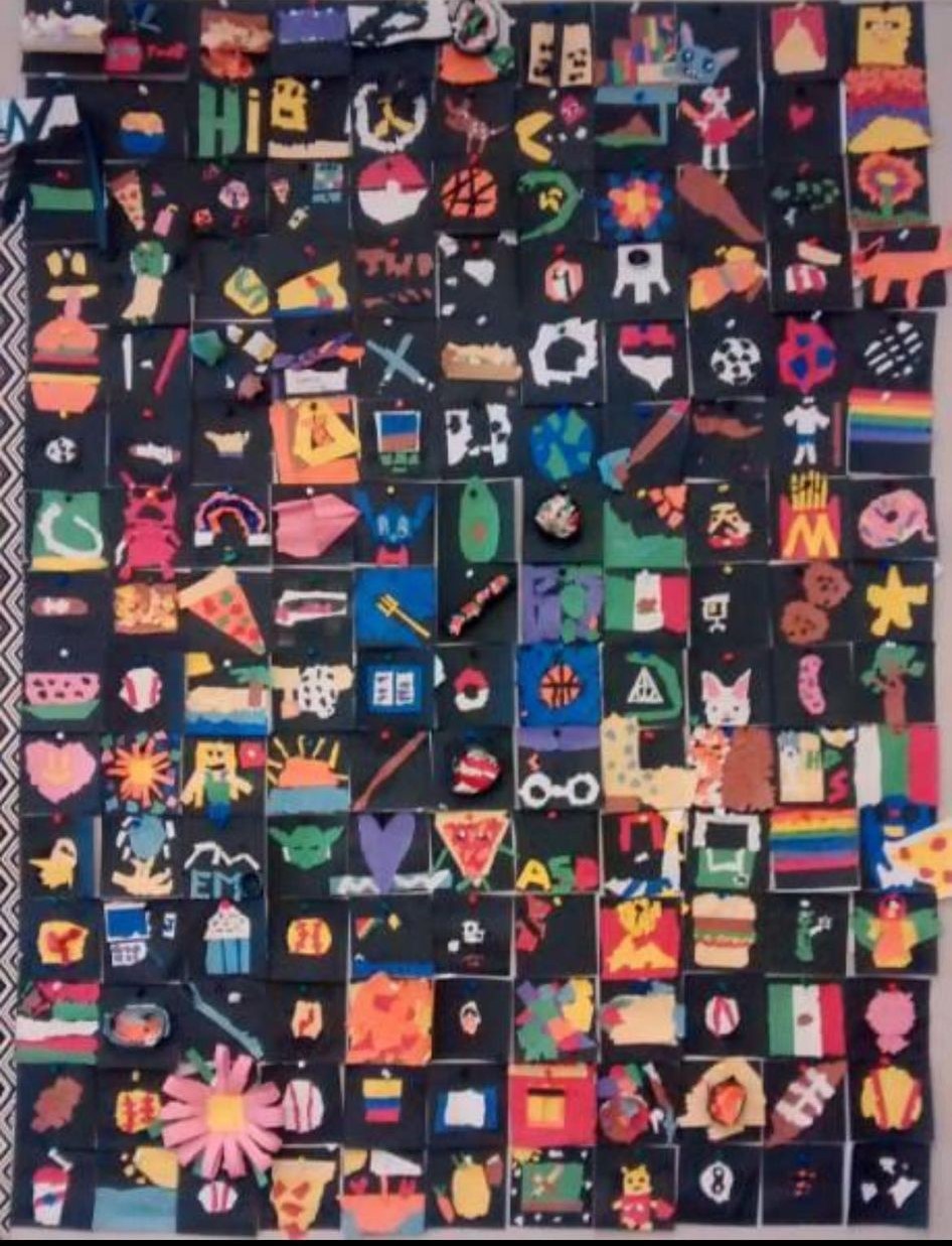 A whole bunch of squares with student are on them come together to form a large paper quilt.