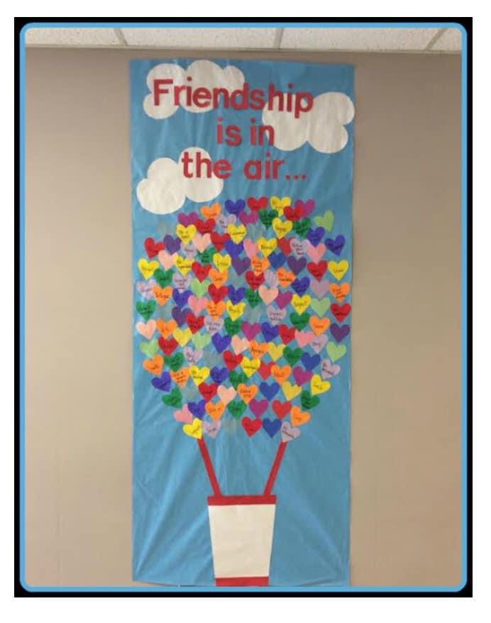 A door says Friendship is in the air. It features a hot air balloon and the top is made up of hearts with each student's names on them.