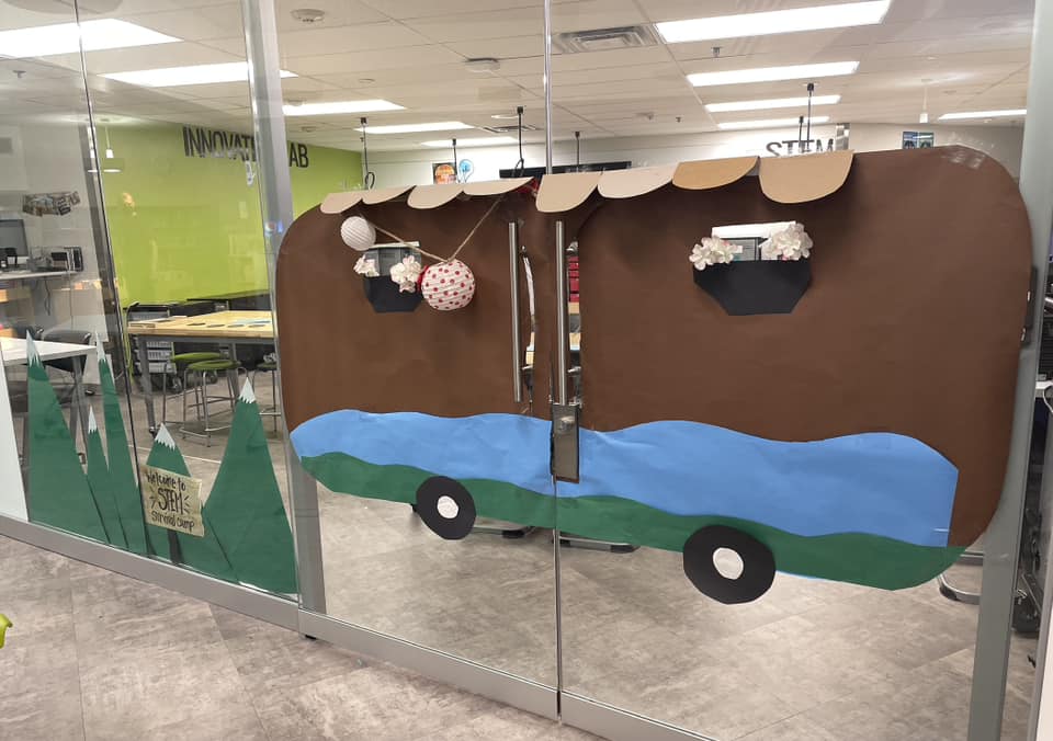 Camping-4 Classroom doors are decorated to look like a brown camper van.