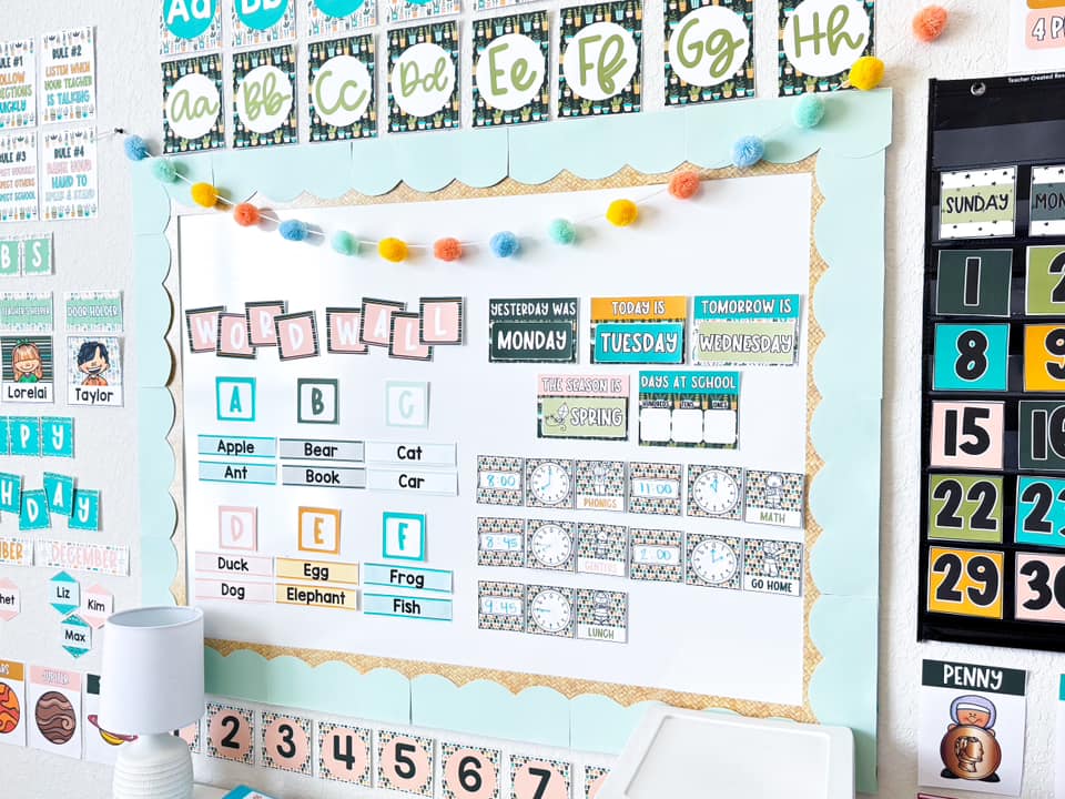 Complete Board A Board says Word Wall and has a few words on it for students to learn. There are other items on the board like clocks showing what time each subject would be taught.