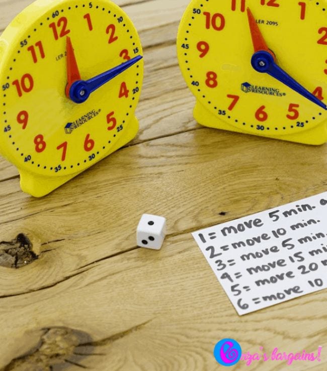42 Best Board Games for Kids, According to Teachers Two toy clocks and a notecard with the rules for the game that is an example of telling time games.