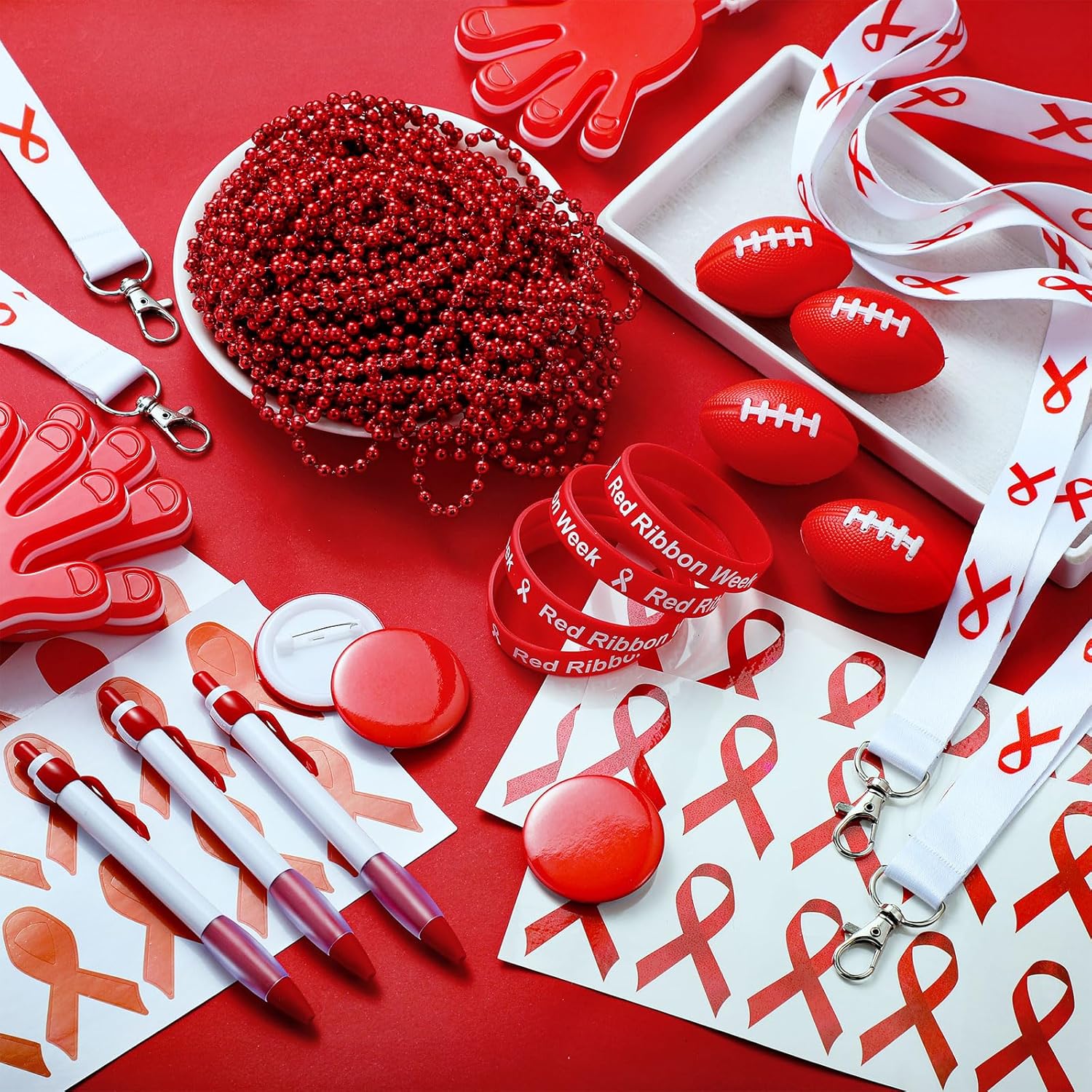 Red Ribbon Week Swag A pile of Red Ribbon Week incentives like beads, footballs, stickers, clappers, and more