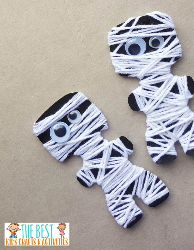 mummy-paper-craft Little black cutouts of people are wrapped in white strings with googly eyes