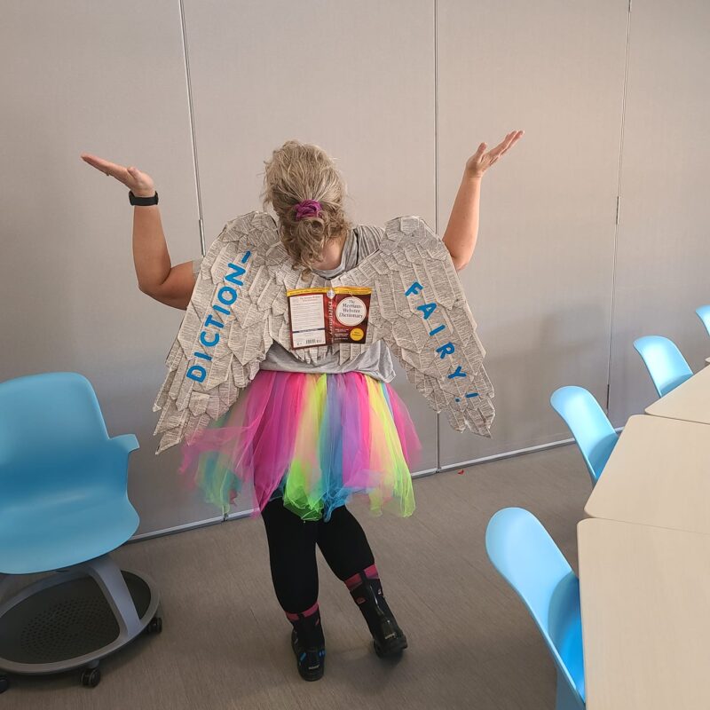 Halloween Costumes: Diction-Fairy Teacher dressed as a Diction-Fairy, with wings covered in book pages