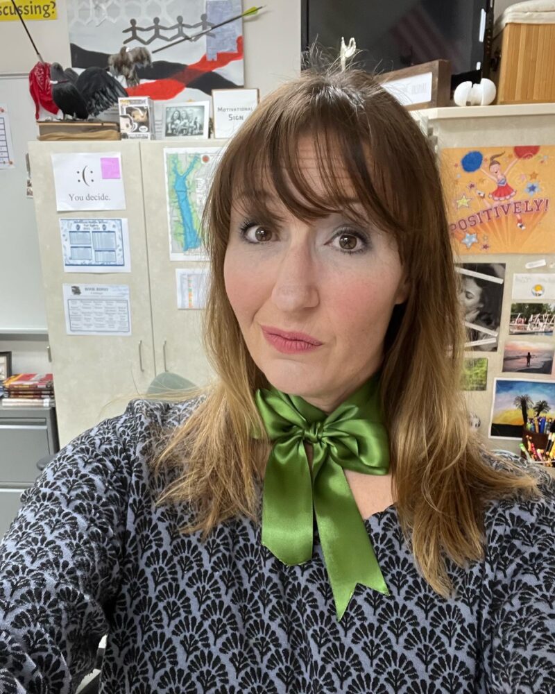 Halloween Costumes: Green Ribbon Teacher wearing a green ribbon bow around her neck