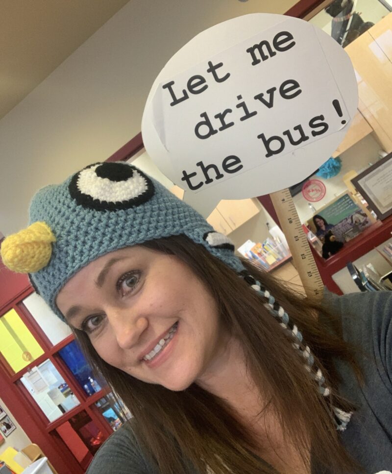 Teacher Halloween Costumes: Pigeon Teacher dressed as Mo Willem's pigeon, with a sign saying Let me drive the bus!