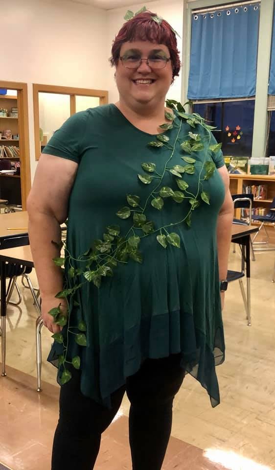 Halloween Costumes: Poison Ivy Teacher wearing a green dress with vines wrapped around it to be Poison Ivy for Halloween