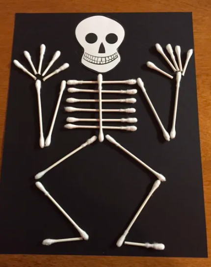 qtip-skeleton A jaunty skeleton made from Qtips glued to black paper as an example of Halloween Crafts for Kids