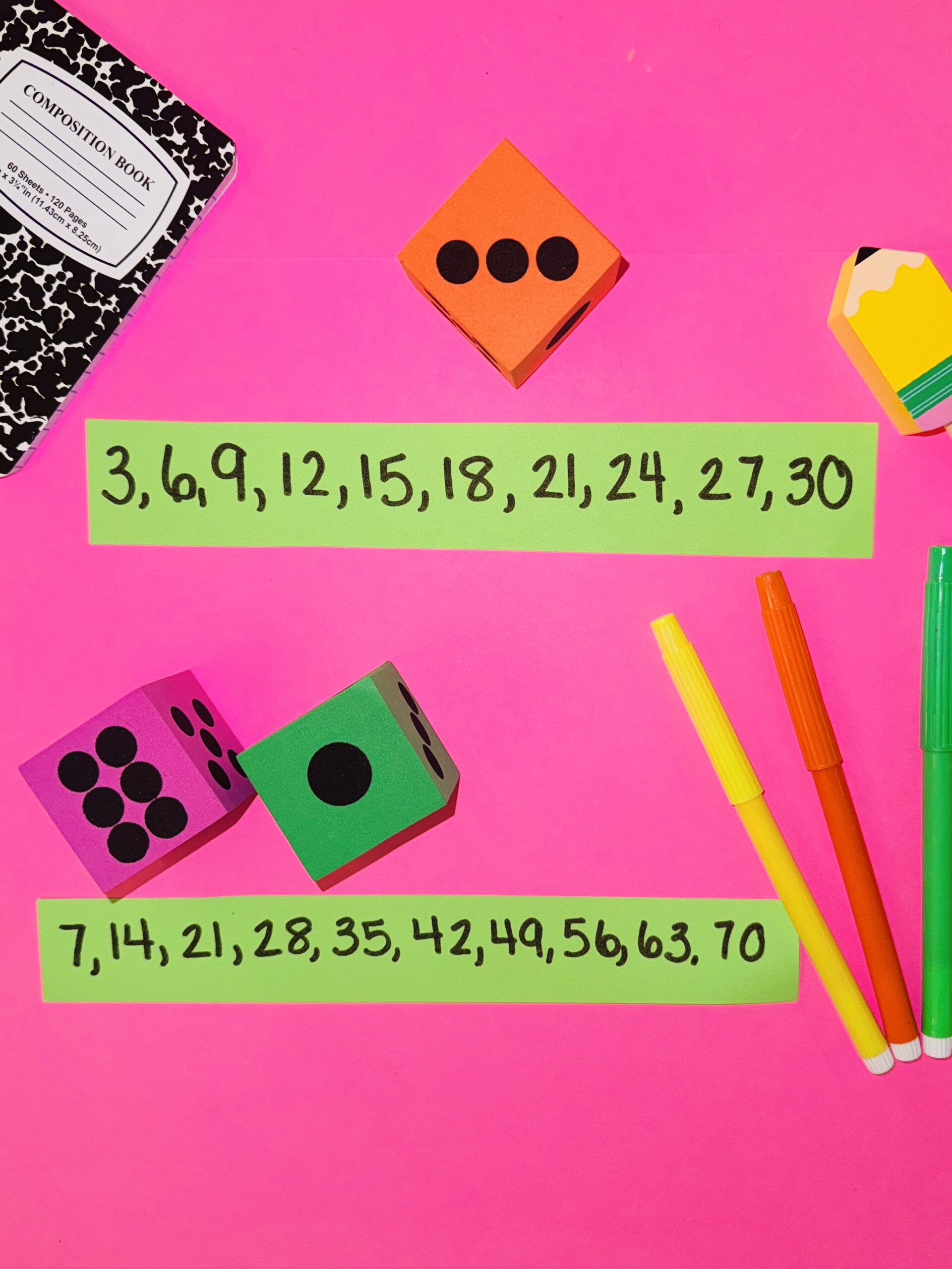 Colored papers with numbers written on them and colorful dice