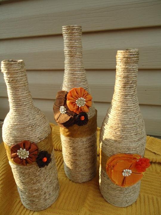twine-bottles Wine bottles are wrapped with twine and decorated with plastic flowers