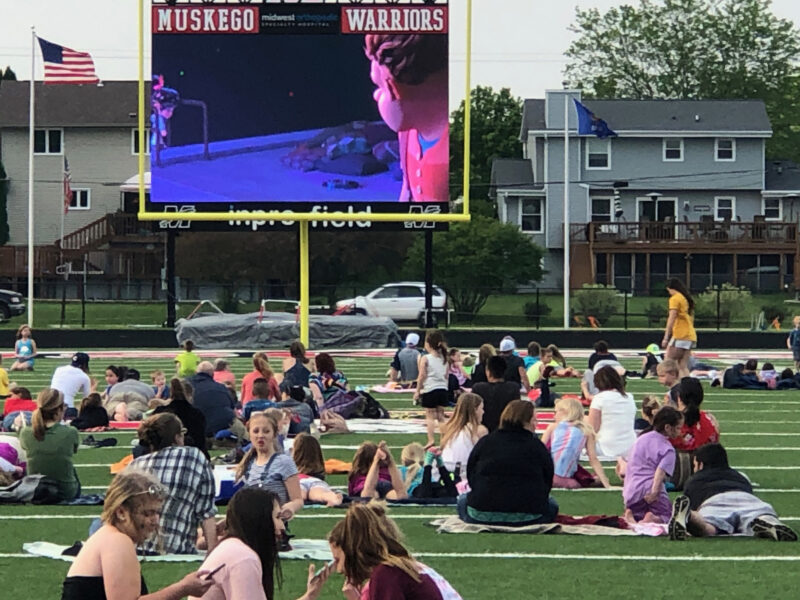 outdoor-movie Students spread out on the football field to watch an outdoor movie