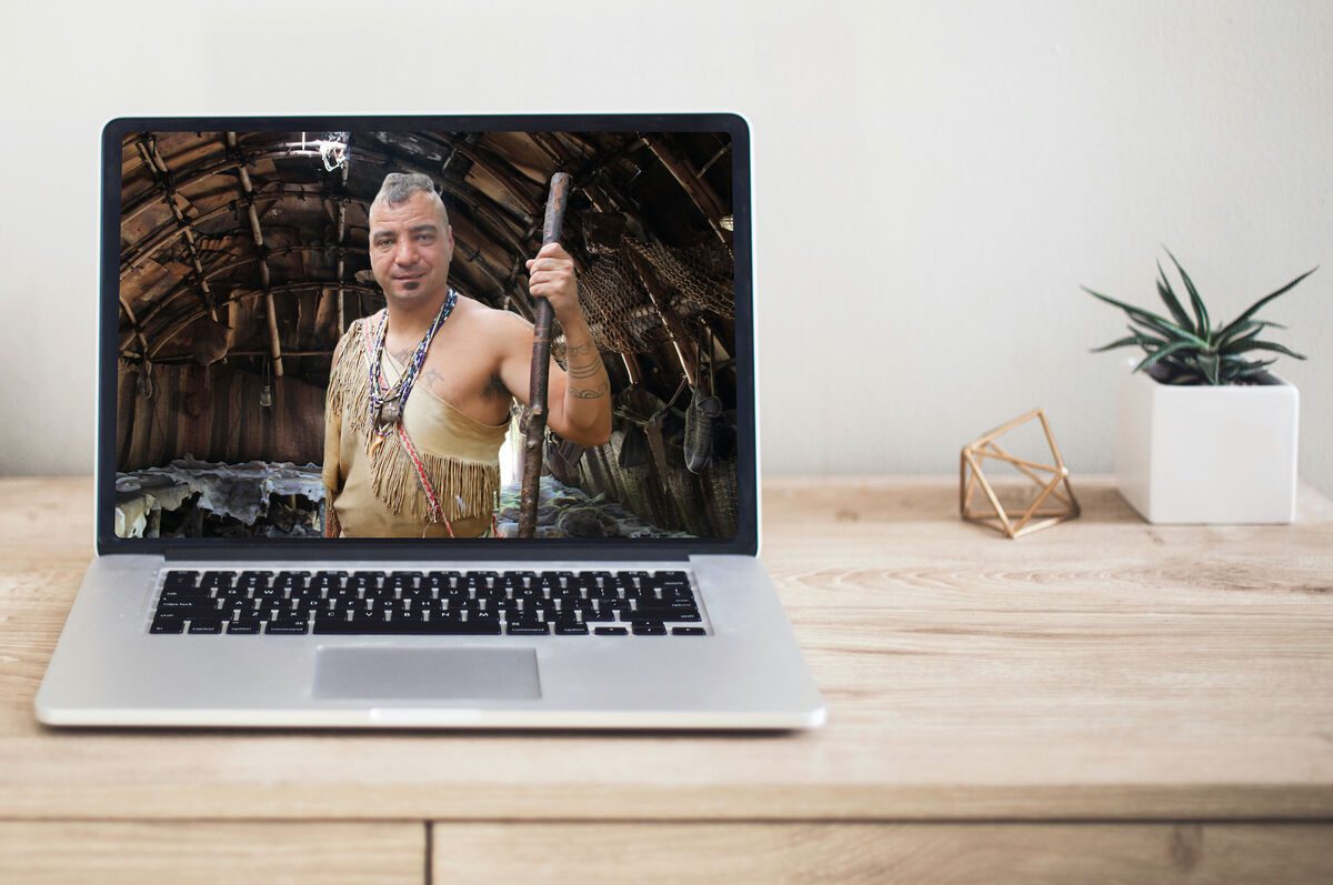 Plimoth Patuxet Virtual Field Trip Desk with laptop featuring a Wampanoag Native American.