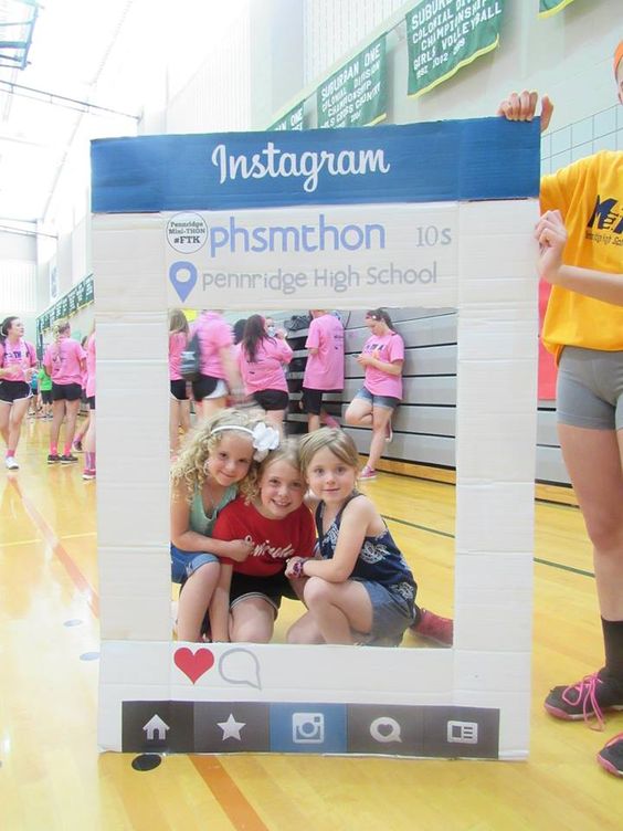 selfie-display Students peek through a selfie display at a pep rally