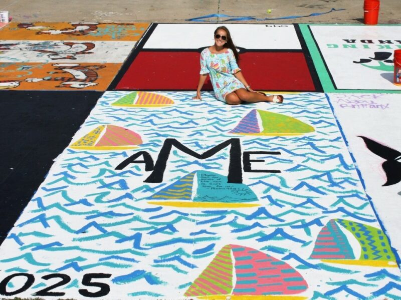 senior-parking-spot A senior in high school sitting in her decorated designated parking spot