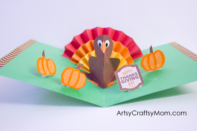 turkey-pop-up-card A pop up turkey sits in the fold of a card made from green construction paper