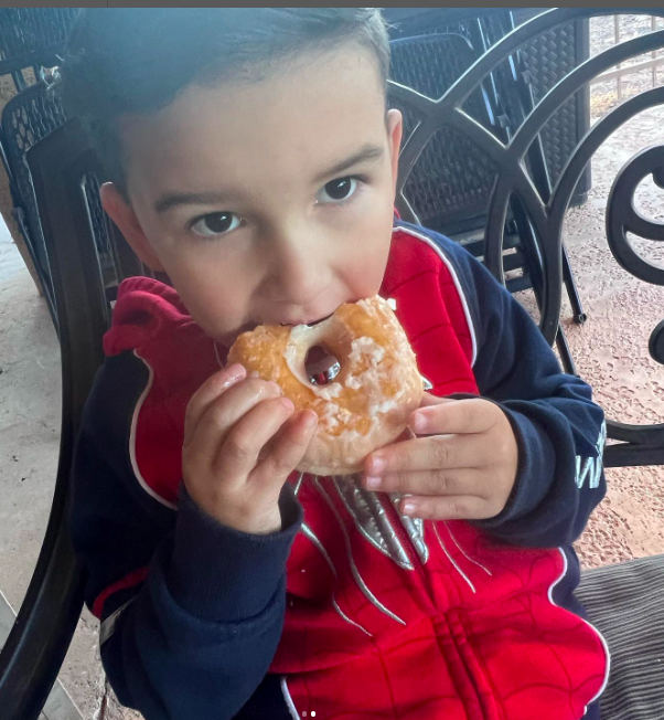 A young boy enjoying a donut