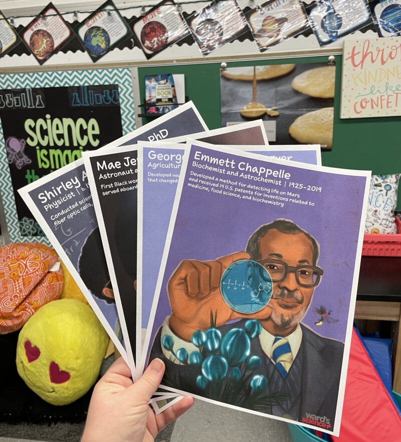 wards-science-black-scientist-posters-ugc Black scientist posters being held up by a teachers in the classroom