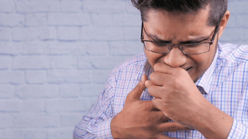 7 Signs You’re Teaching in a “Sick School” Young man in button down business shirt coughing into his hand