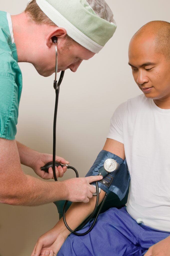 Nurse A nurse takes a man's blood pressure