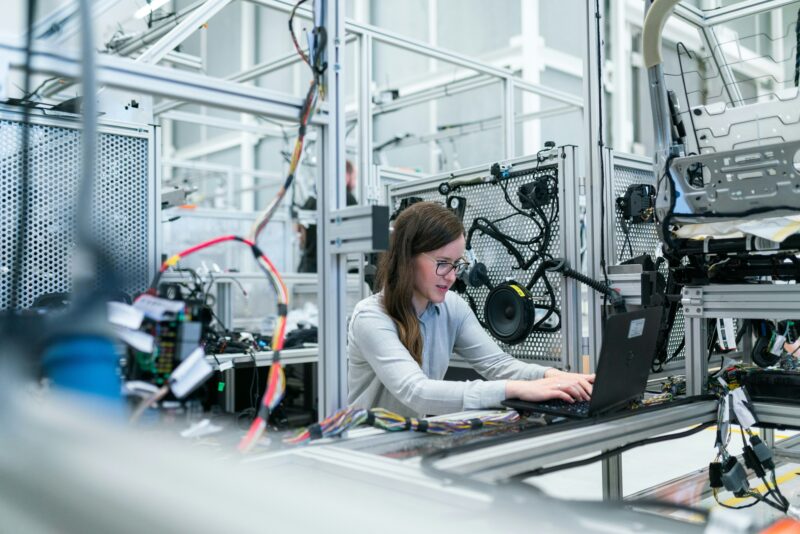 An IoT engineer tests smart equipment using a laptop