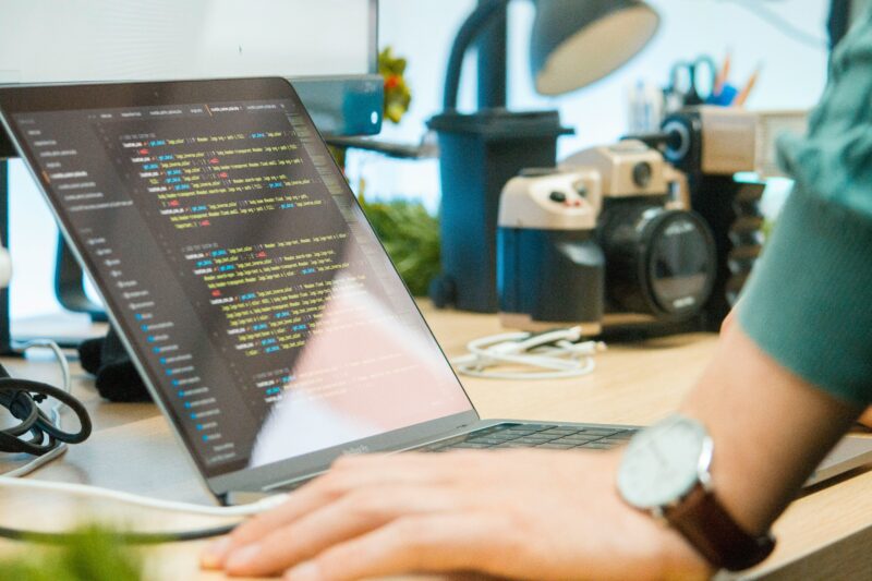 Machine learning engineer works at a laptop writing code