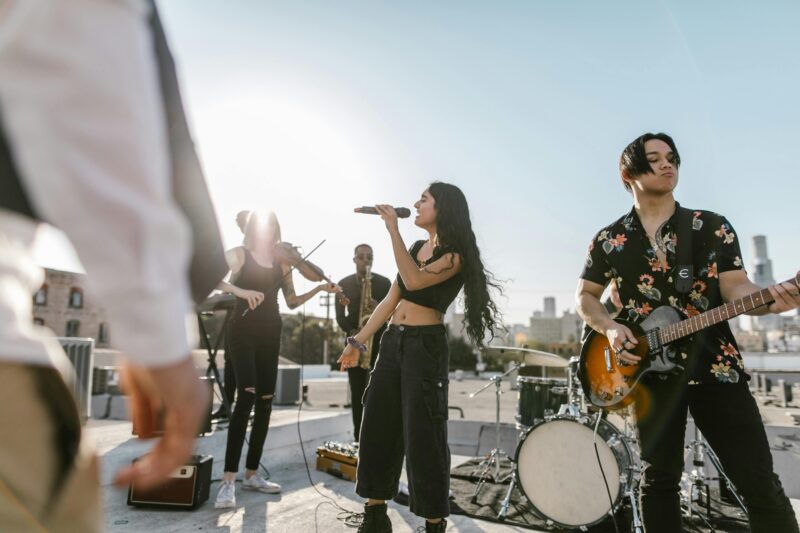 Several members of a music band are shown singing or playing instruments in this example of music careers.
