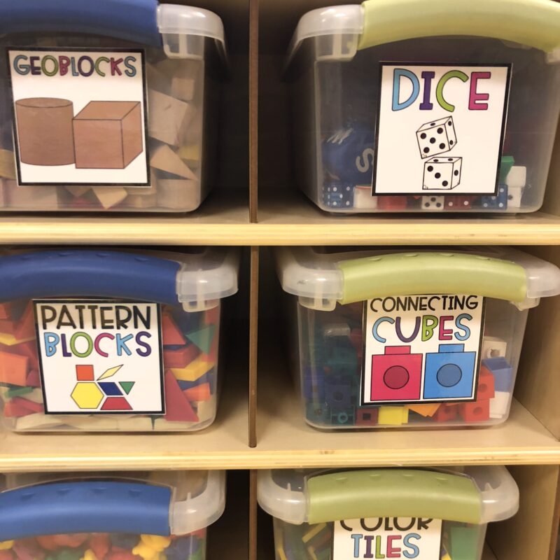 Labeled Storage Bins Classroom storage bins labeled with words and pictures.