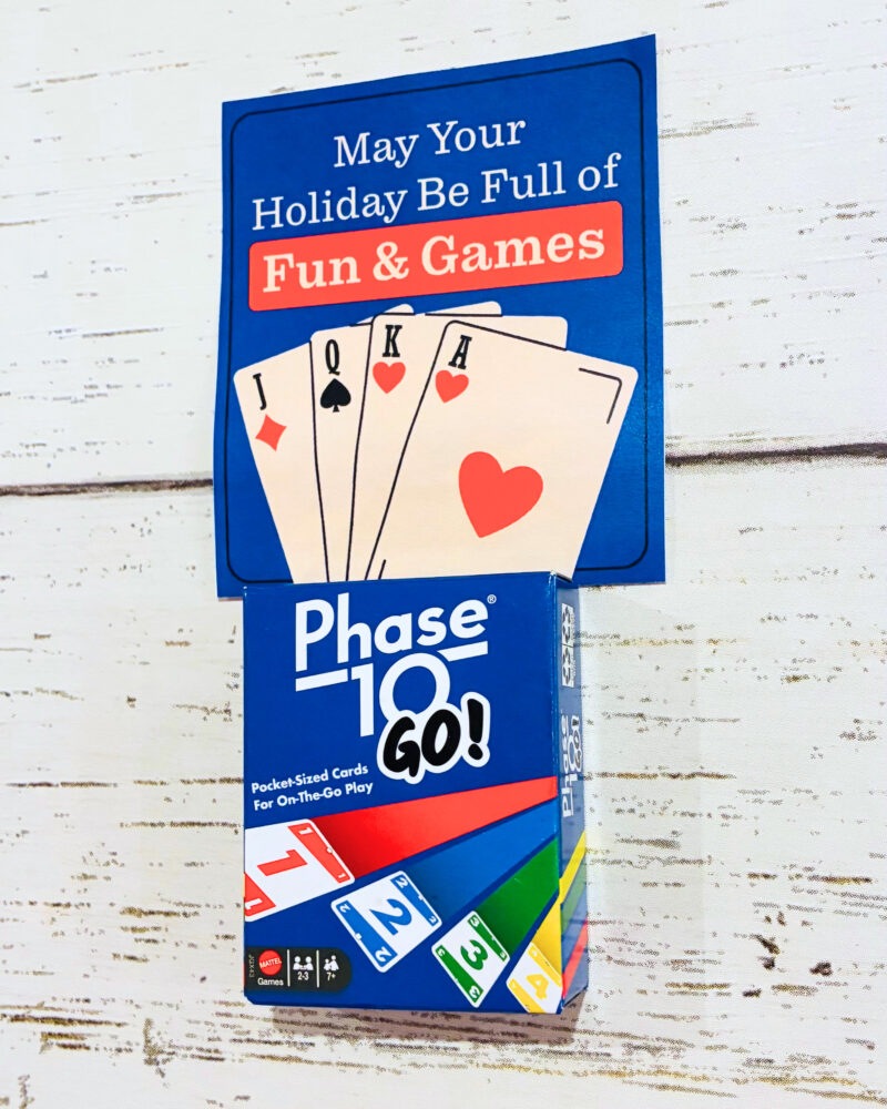 holiday gift tag example for a student gift that says may your holiday be full of fun and games with a small pack of phase 10 cards