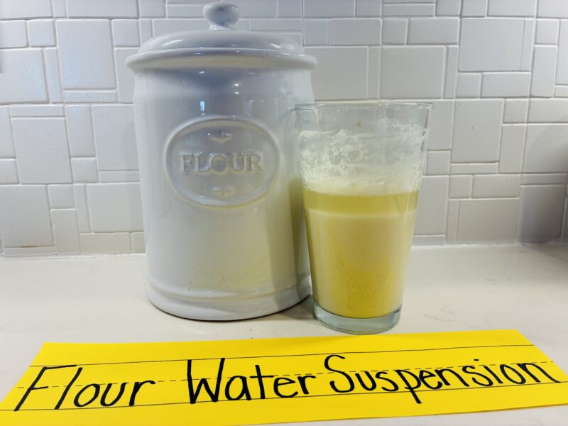 an image of a flour water suspension experiment with a flour container and a glass that has flour and water mixed together