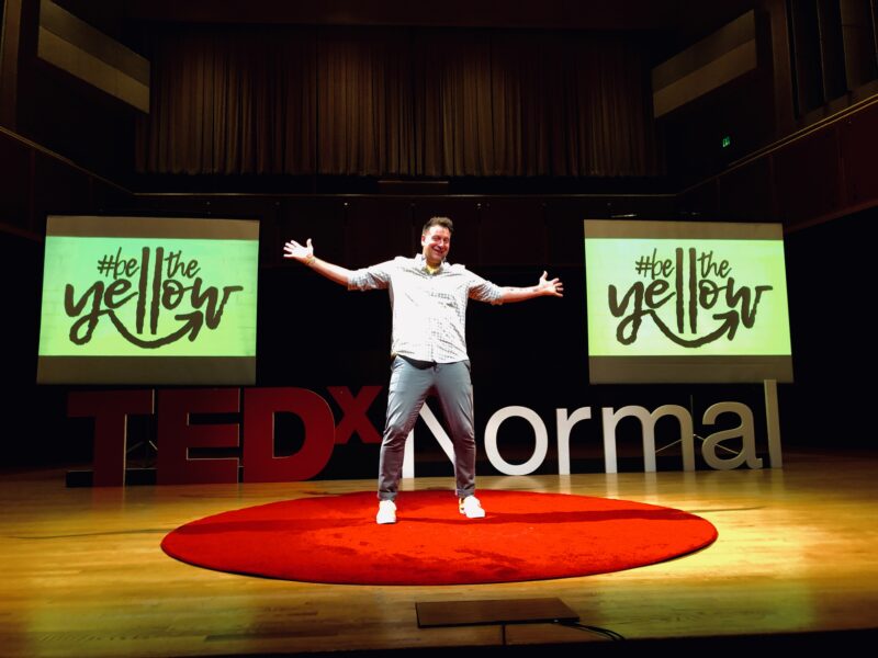 Adam Peterson on the TEDx stage.