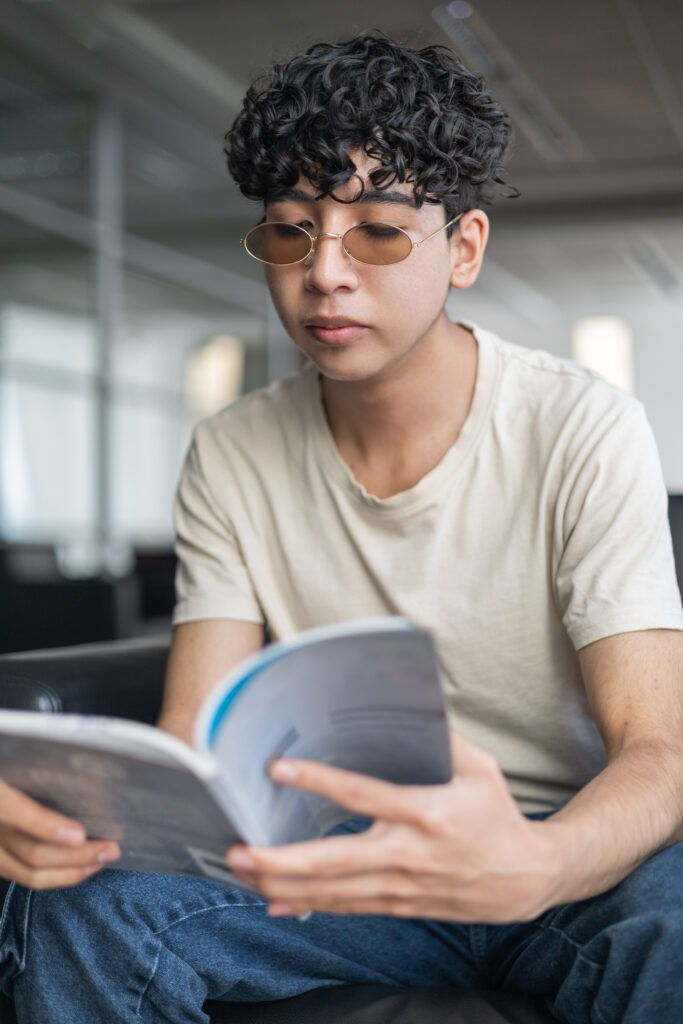 A person reading a manual to understand instructions, focused on learning. Ideal for themes of education, self-learning, and problem-solving.