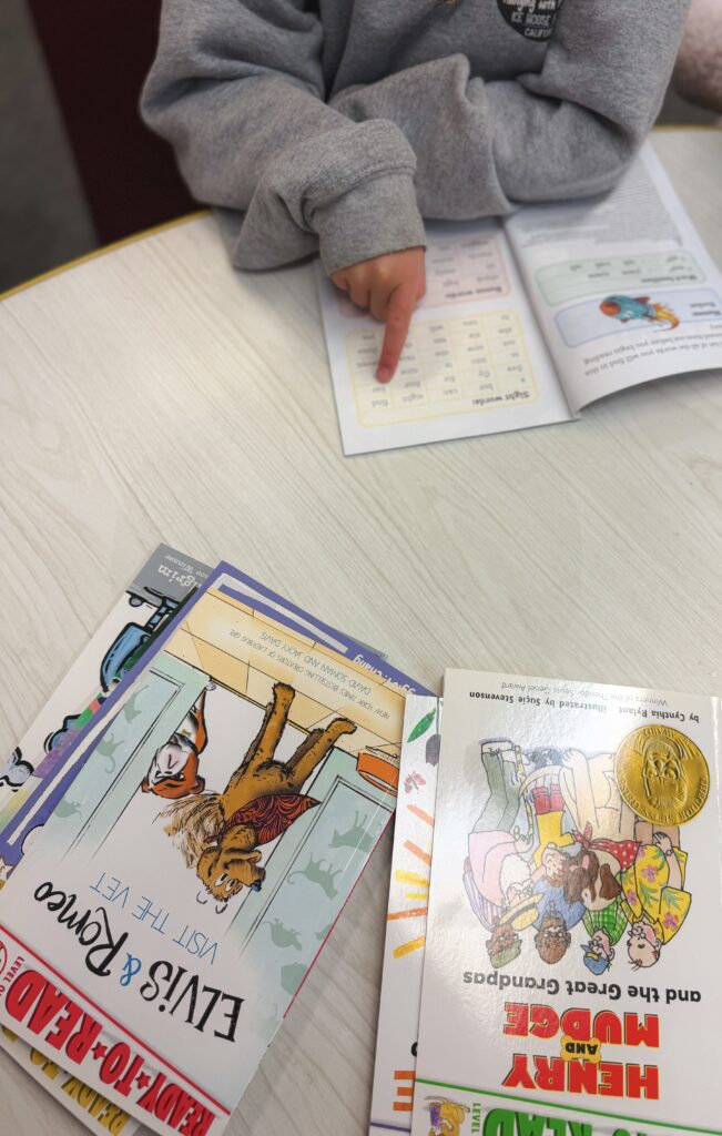 Student and Simon & Schuster Ready to Read books